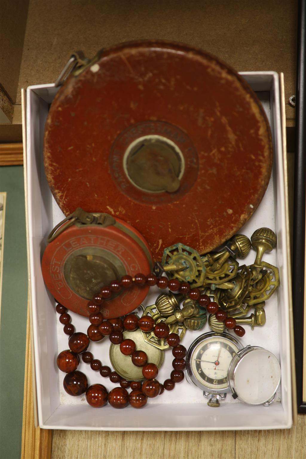 A military compass, bakelite amber beads, other miscellaneous items